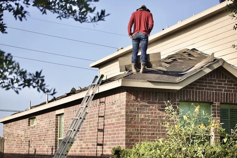 Professional roofer working on a residential roof in Pullen